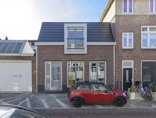 De tweelaagse woning is strak tussen de belendingen gebouwd. 